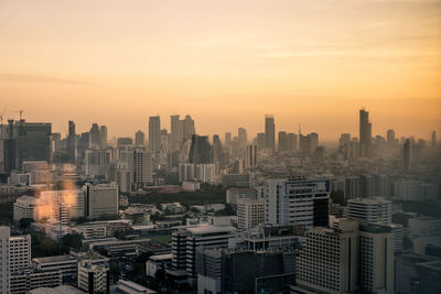 High angle view of buildings in city against sky during sunset