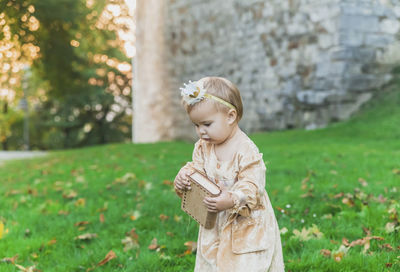 Portrait of young woman standing on field