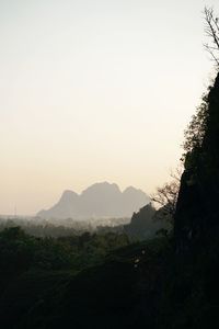 Scenic view of mountains against clear sky at sunset