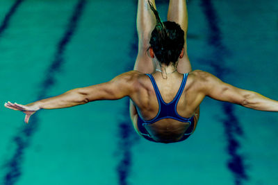 Swimmer diving into pool