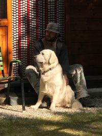 Portrait of man sitting with dog