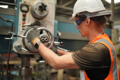 Portrait of male worker standing in the heavy industry manufacturing factory.