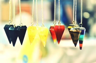 Close-up of multi colored umbrellas hanging against blurred background