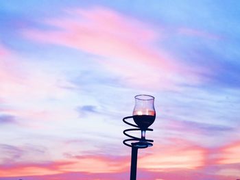 Low angle view of street light against cloudy sky