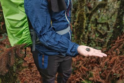 Midsection of man standing in forest