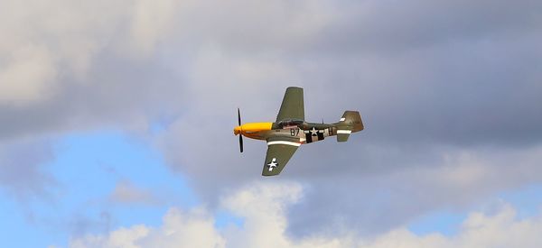 Low angle view of airplane flying against sky