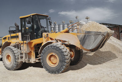 Low angle view of vehicle on field against sky