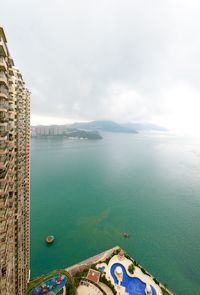 Building by sea against sky