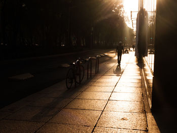 Man riding bicycle on footpath in city