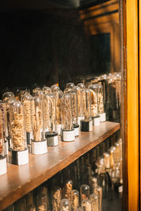 Close-up of bottles filled with seeds on table