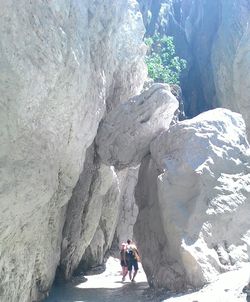 Tourists on rock formation at seaside