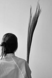 Rear view of woman with long hair against clear sky