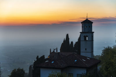 Sunset from the cormons hill. among fog, vineyards and fiery colors. italy