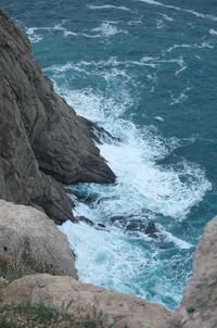 High angle view of rocks at sea shore