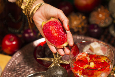 Midsection of woman holding strawberries