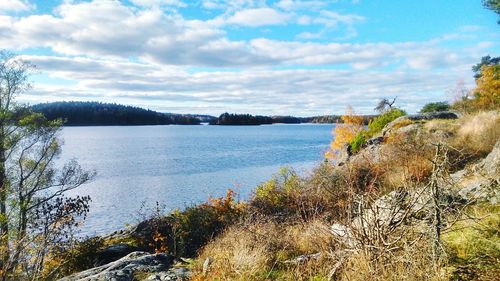 Scenic view of lake against cloudy sky