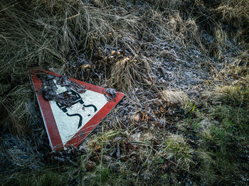 High angle view of road sign on field