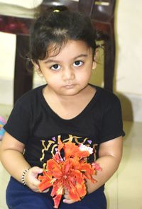 Portrait of a girl with red flower