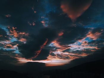 Silhouette landscape against scenic sky