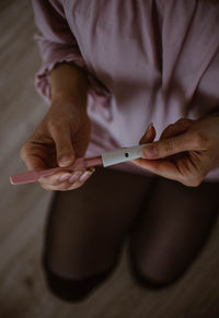 Close-up of man holding hands on table