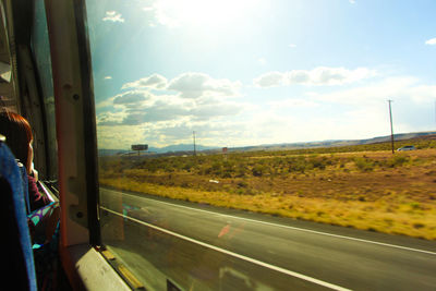 Road seen through train window