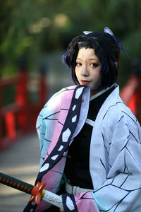 Portrait of young woman standing outdoors