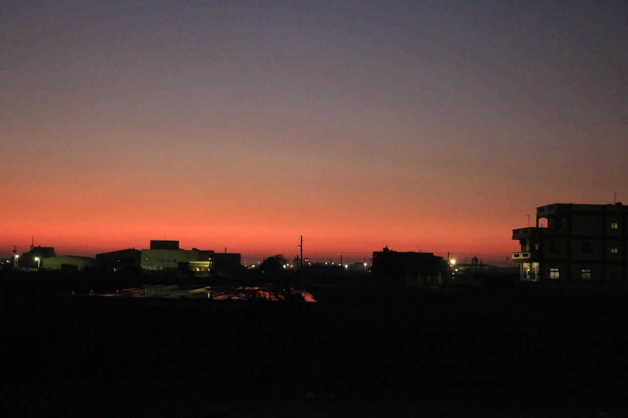 building exterior, architecture, sunset, built structure, copy space, city, illuminated, silhouette, clear sky, orange color, residential structure, cityscape, residential building, dusk, dark, sky, residential district, night, building, outdoors