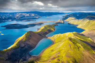 Aerial view of lake and mountains against sky