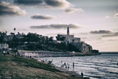 Scenic view of beach against cloudy sky