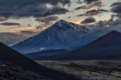 Scenic view of snowcapped mountains against sky during sunset