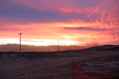 Scenic view of landscape against orange sky