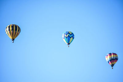 Low angle view of hot air balloons in air