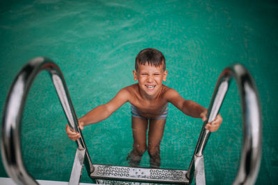 Portrait of smiling boy in swimming pool