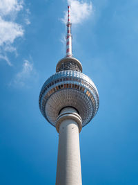 Low angle view of tower and building against sky