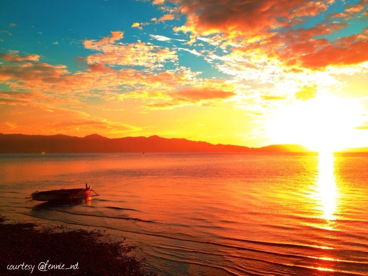 sunset, water, sun, scenics, beauty in nature, sea, sky, tranquil scene, orange color, tranquility, cloud - sky, nature, idyllic, nautical vessel, reflection, beach, sunlight, mountain, sunbeam, shore