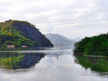 Scenic view of lake and mountains against sky