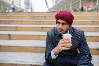 Portrait of mid adult man holding coffee cup