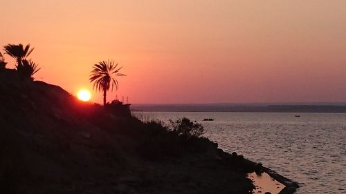 Scenic view of sea against sky at sunset