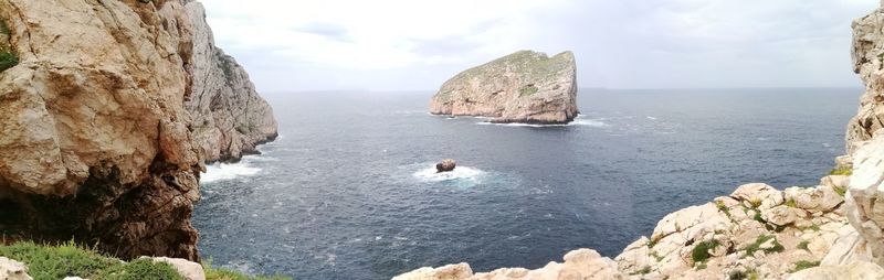 Panoramic view of rocks in sea against sky