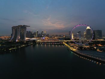 Illuminated city by river against sky  at benjamin sheares flyover, singapore