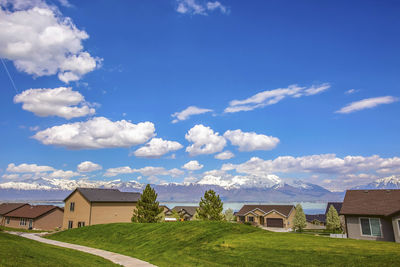 Houses on field against sky