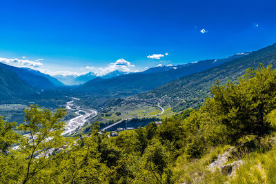 Scenic view of mountains against blue sky