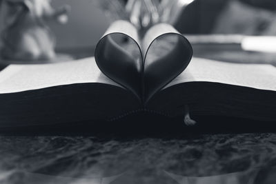 Close-up of heart shape on book