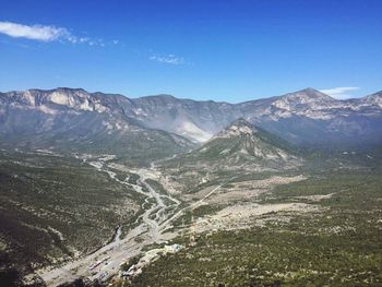 Scenic view of mountains against blue sky