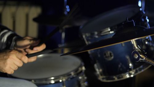 Cropped image of drummer playing drums