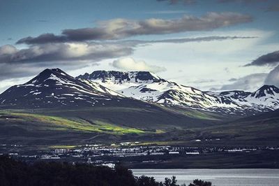 Scenic view of mountains against cloudy sky