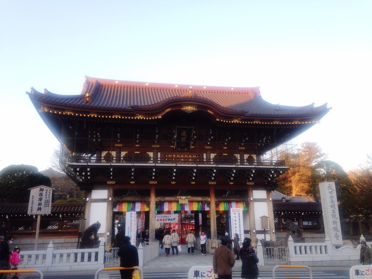 architecture, built structure, building exterior, temple - building, place of worship, large group of people, person, clear sky, religion, famous place, spirituality, low angle view, travel destinations, tourism, sky, history, tradition, men