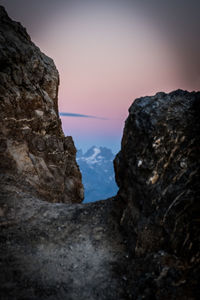 Low angle view of rock formation against sky at sunset