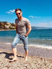 Full length of young man standing on beach