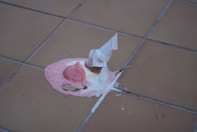 High angle view of pink paper on footpath